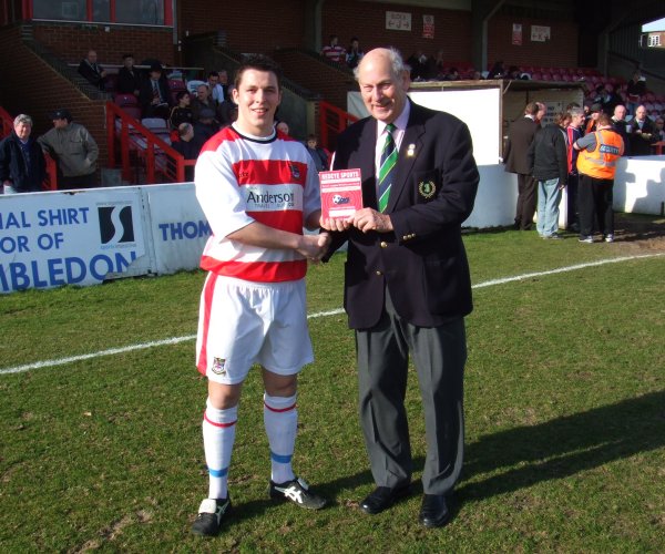 Bobby Traynor presented with award by league official Barry Simmons