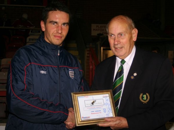 Luke Garrard presented with award by league official Barry Simmons