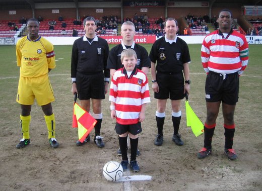 K's mascot James Crawt lines up with captain Rob Paris