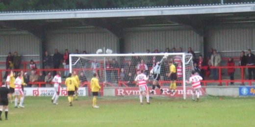 Wastell and the bar combine to stop the corner ball