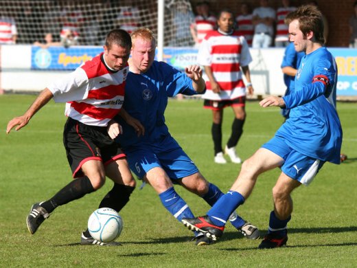 Jason Turley battles former K's players Craig Lewington and Scott Harris