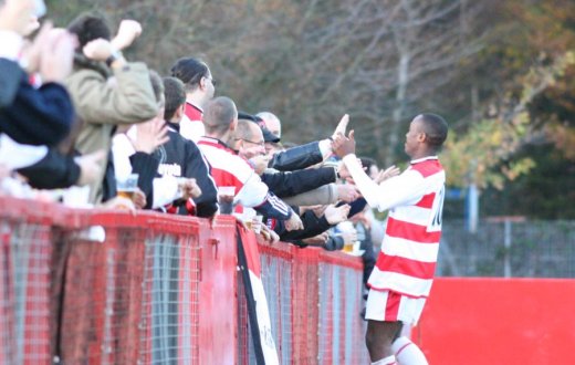 Saheed Sankoh celebrates with the travelling support