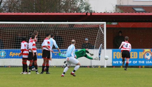 Luke Garrard fingertips a free kick past the post