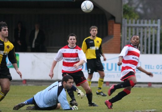 ...Lodge lifts the ball past the goalkeeper