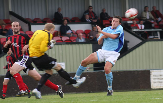 Rob French clears as Bobby Traynor chases down