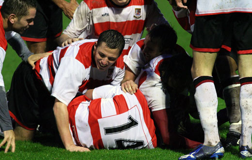 Teammates mob goalscorer Jon Neal