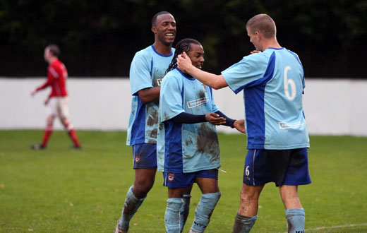 Simon Huckle and Carl Wilson-Denis congratulate Dean Lodge on the third