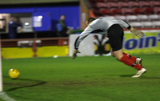 Barry Andrews recovers to gather a spilt ball