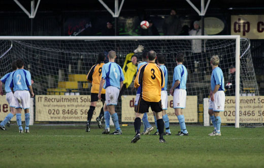 Luke Garrard tips over a Colin Luckett free kick