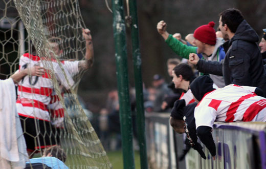 Players and fans celebrate the second goal