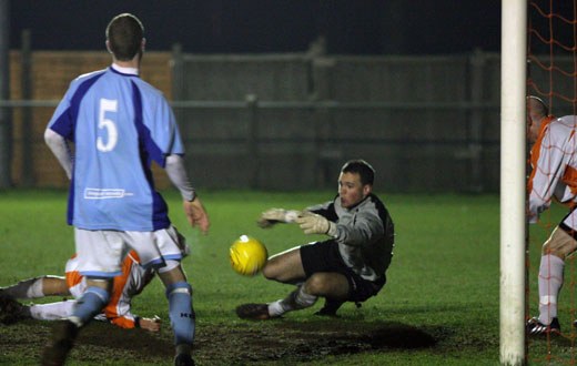 Home goalkeeper makes a save