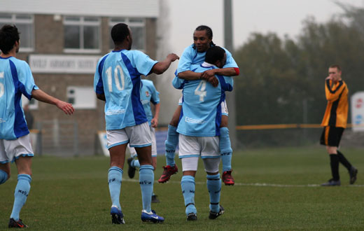 Teammates celebrate Thompson's goal