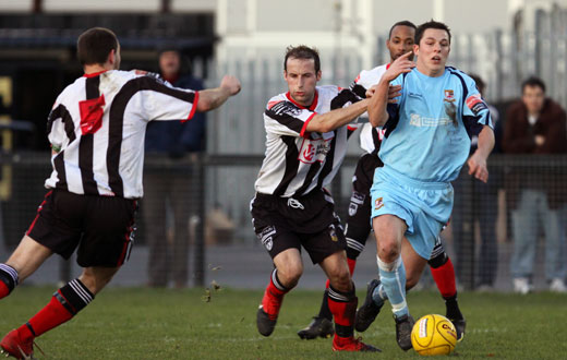 Bobby Traynor is fouled by his opponents...