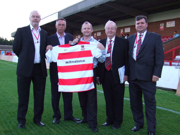 Left to right: Malcolm Winwright (Joint-Chairman, Kingstonian FC), Calvin Avery (Director, TMG Fire & Security Ltd), Stephen Coulson (Director, TMG Fire & Security Ltd), Lawrence Cooley (President, Kingstonian FC), Mark Anderson (Joint-Chairman, Kingstonian FC)